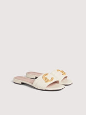Coccinelle women's C-Me sandal with open toe and ankle strap, featuring nude-colored leather and stylish design.