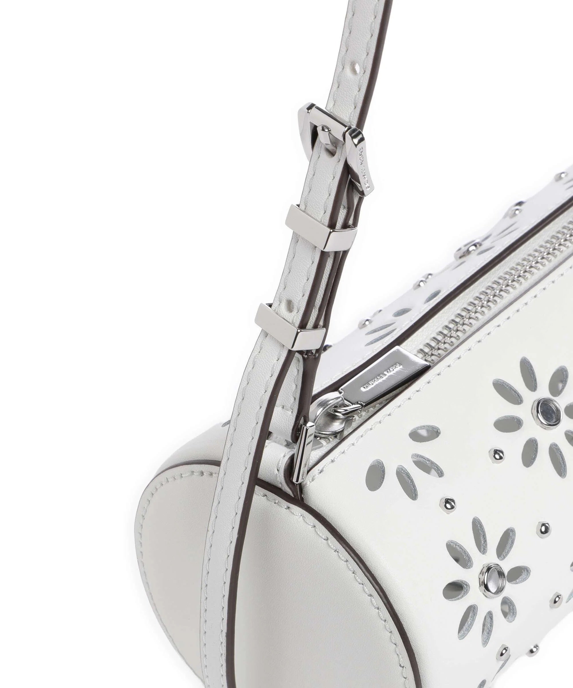 Dettaglio della Borsa Izzy Michael Kors bianca con manico regolabile, zip argento e motivo floreale traforato con cristalli.