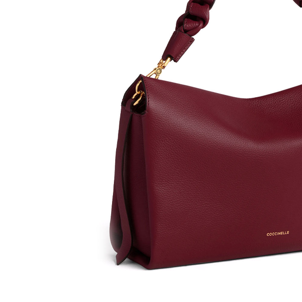 Medium Coccinelle leather shoulder bag with bohemian design, featuring a stylish and versatile handbag for women.