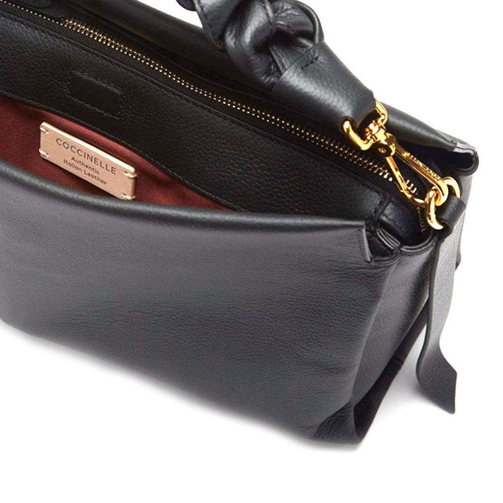 Medium leather shoulder bag by Coccinelle, bohemian style with adjustable strap and spacious interior, in a versatile design.