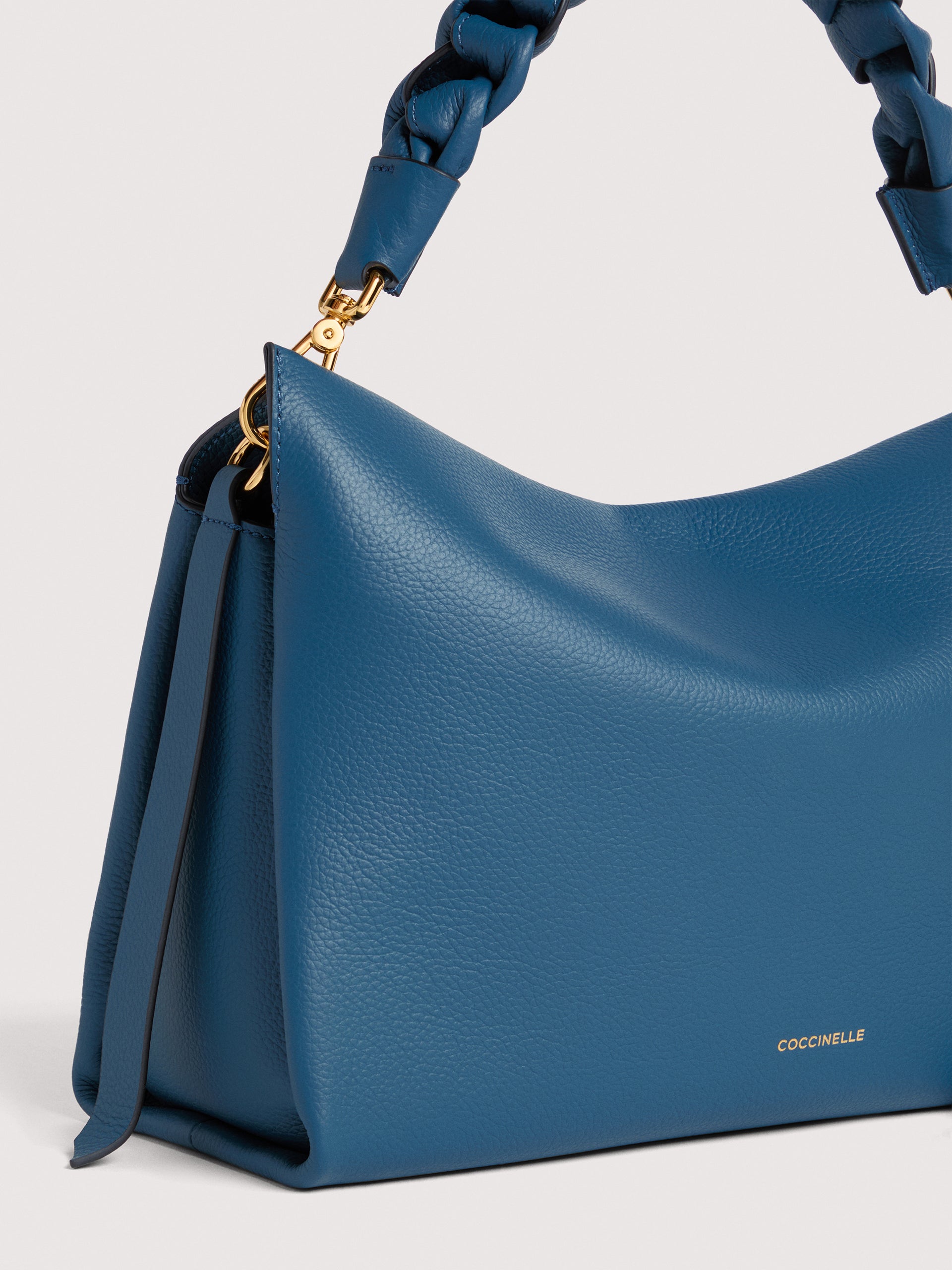 Medium Coccinelle Boheme leather shoulder bag with adjustable strap, stylish accessory for women.