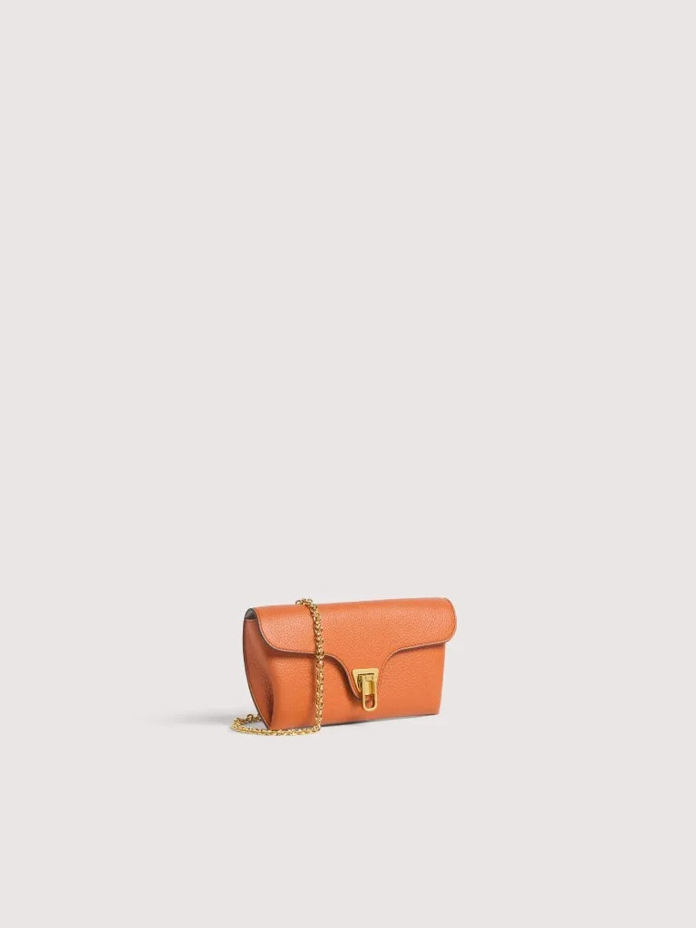 Coccinelle Double Beat shoulder bag in black leather with silver hardware, featuring a structured design and top handle.
