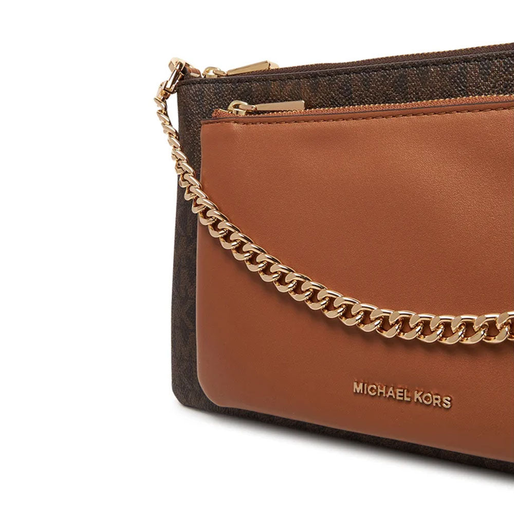 Medium Jet Set Michael Kors handbag with gold-tone hardware, featuring signature logo pattern and top handles.
