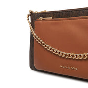 Medium Jet Set Michael Kors handbag with gold-tone hardware, featuring signature logo pattern and top handles.