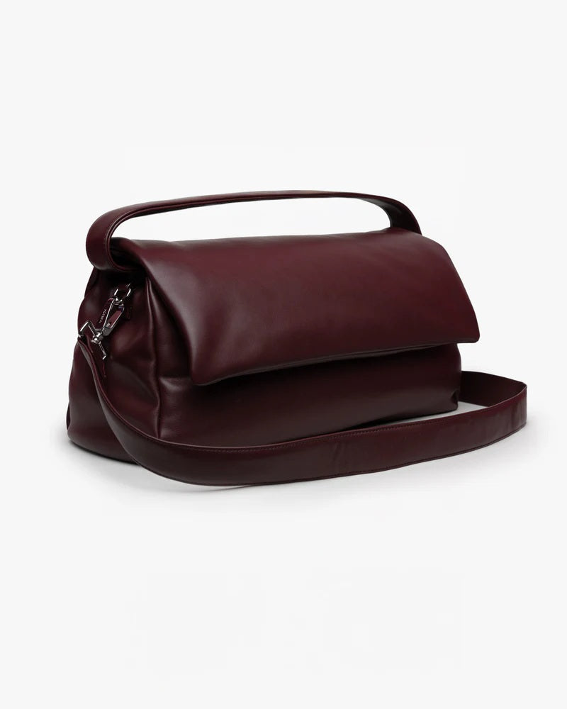 Borsa Puffy Mabash The New Deaux in pelle vegana color bordeaux, dotata di manico e tracolla staccabile, fotografata su sfondo bianco.