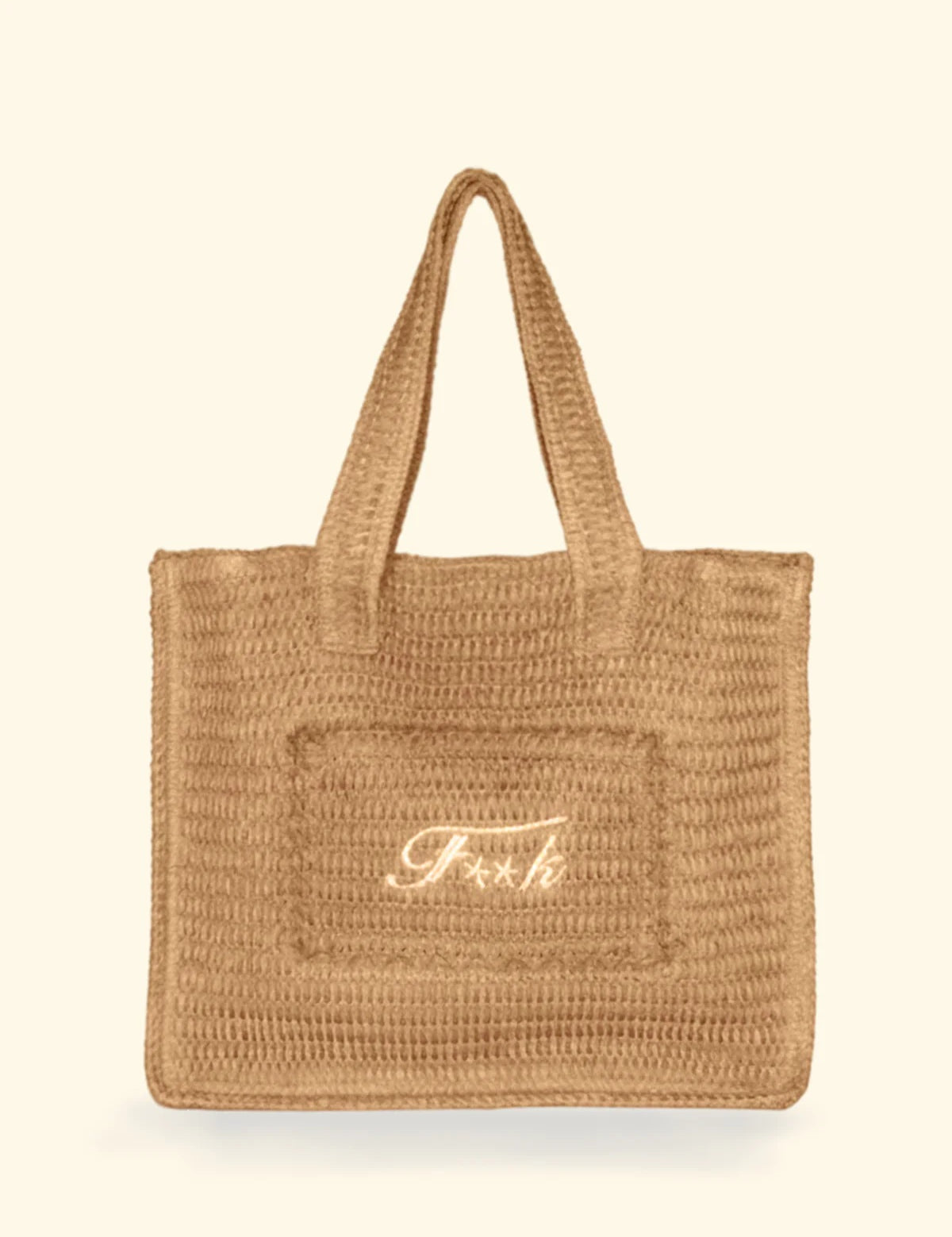 Borsa mare in rafia modello Tote Bag del brand F**K con scritta ricamata color panna su fondo neutro.