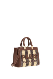 Mini tote bag in tan leather by Rue Madam, featuring sleek design and compact size, ideal for everyday use.