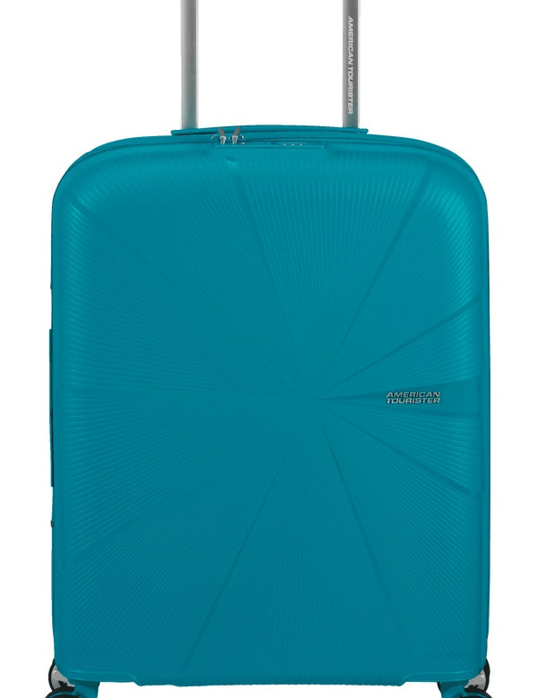 Expandable American Tourister Starvibe cabin trolley suitcase with four wheels and a retractable handle for travel.
