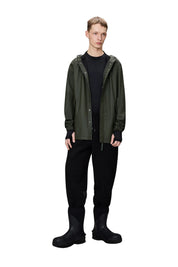 Unisex Rains fishtail jacket in waterproof material, featuring a sleek trench style with a distinctive fishtail hem.