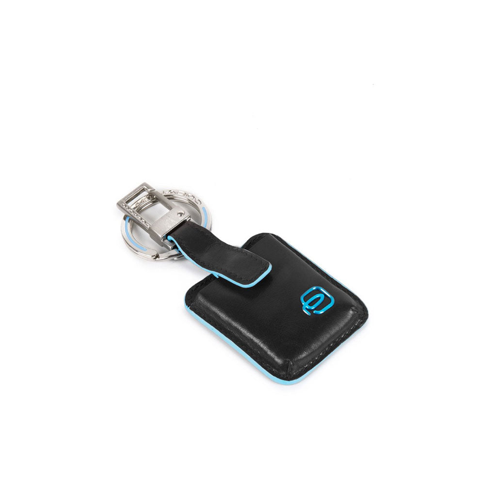 Blue Square Piquadro Connequ unisex keychain with metal logo, attached to a set of keys, stylish and functional accessory.