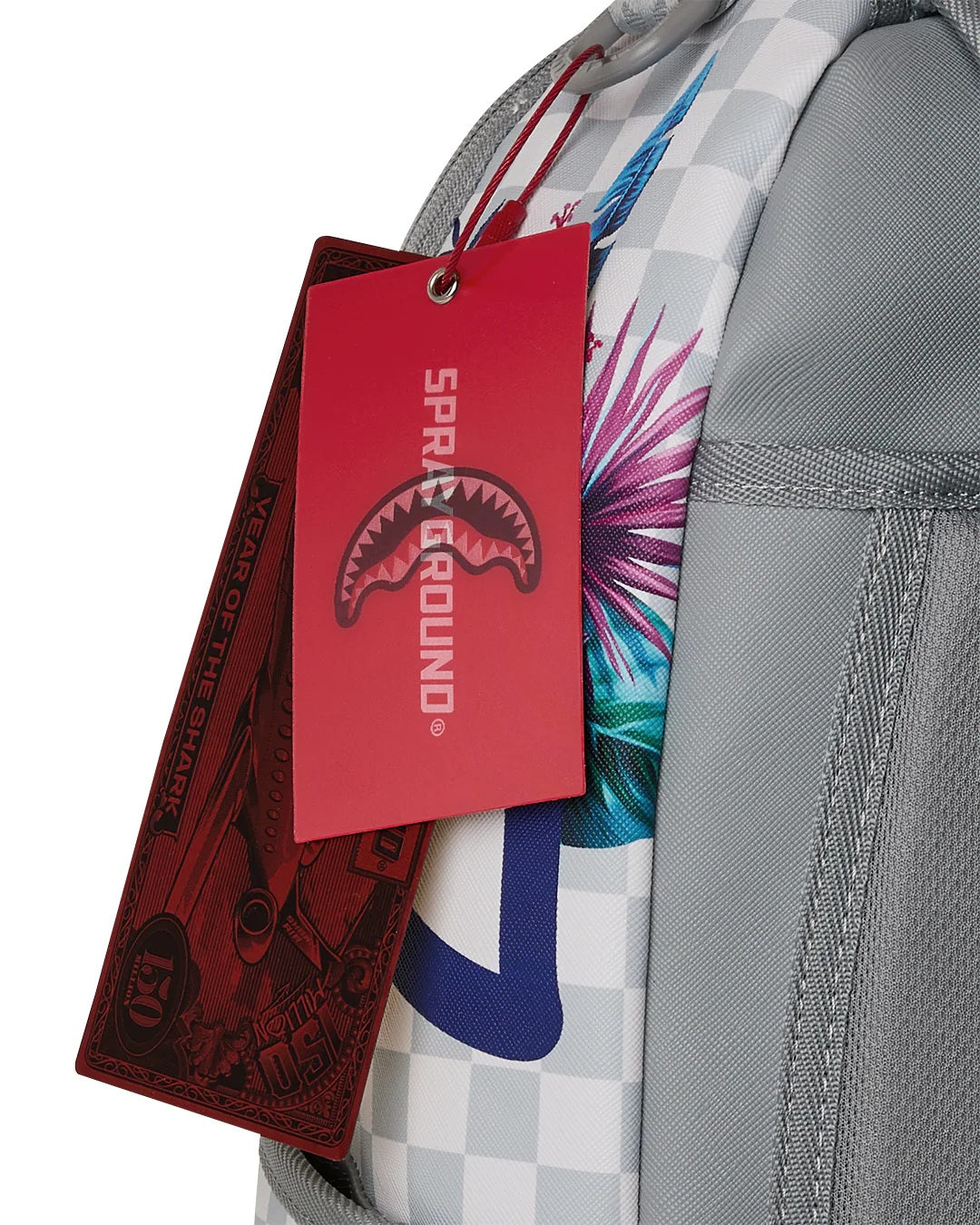 Cream flowering jungle Shark Dlxsv backpack by Sprayground, unisex accessory with vibrant floral and shark design on the backpack.